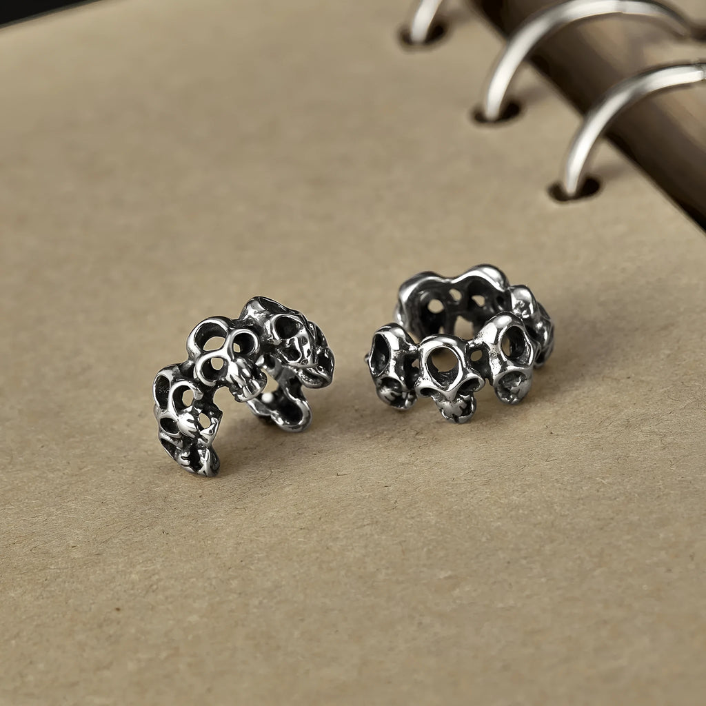 Stainless steel skull earrings with hollow geometric design and ear clip fastening