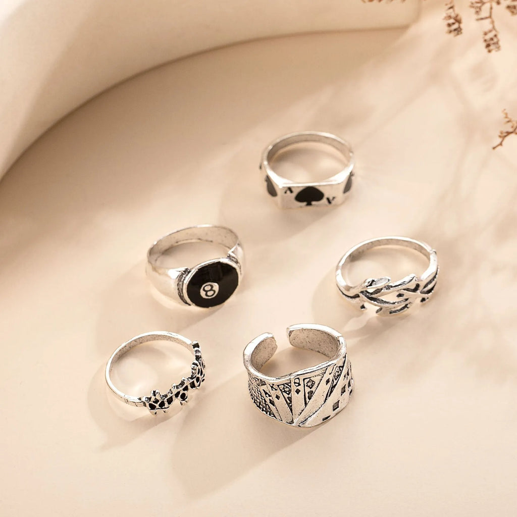 Black alloy poker ring with a raised retro spade card design on its face.