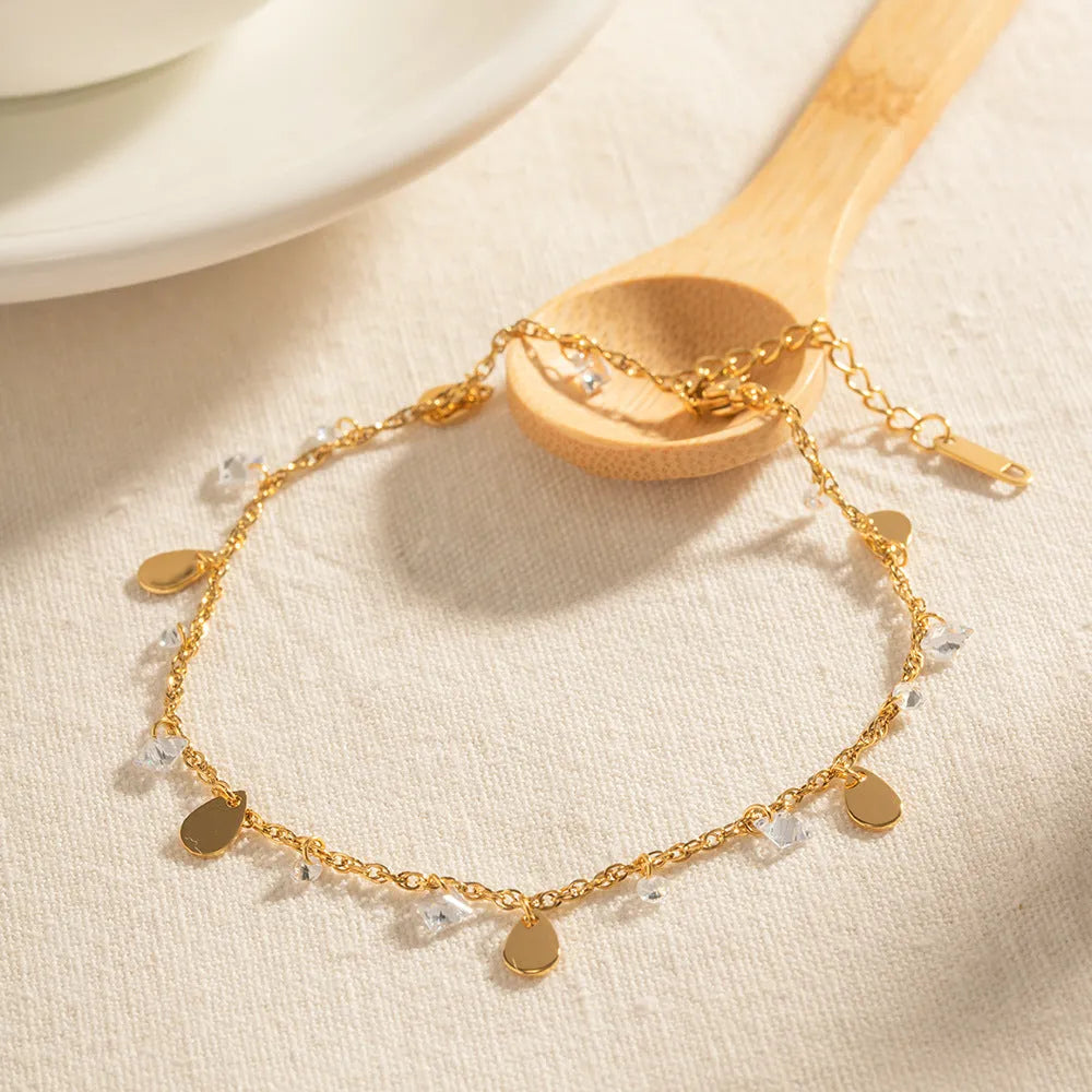 Silver-tone stainless steel anklet with a geometric water drop tassel charm on an adjustable chain.
