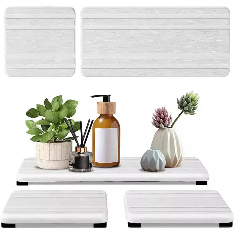 Set of three solid colour diatomite square drying mats for bathroom countertops.