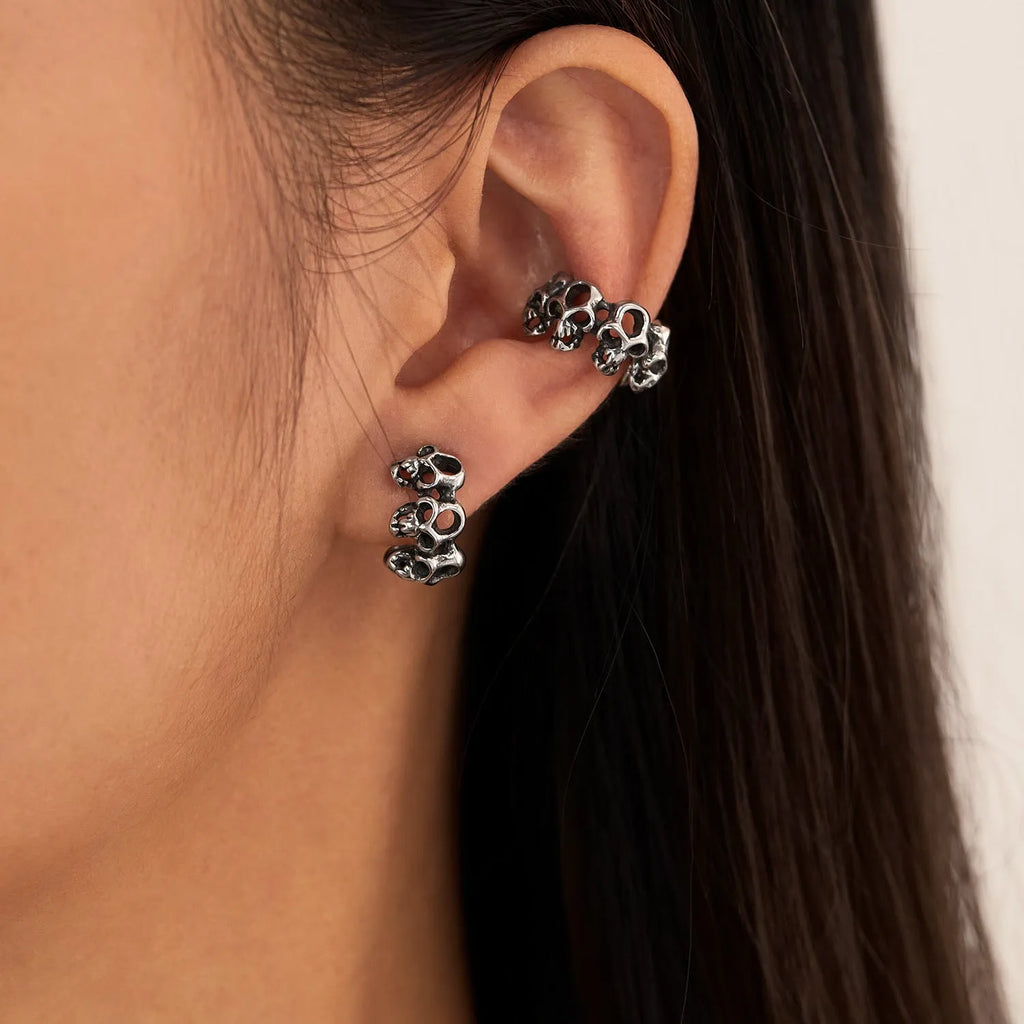 Stainless steel skull earrings with hollow geometric design and ear clip fastening