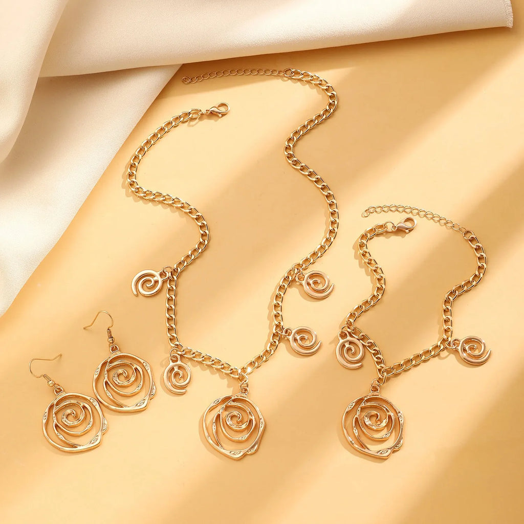 Women's spiral donut jewellery set showing necklace, bracelet and earrings in gold finish