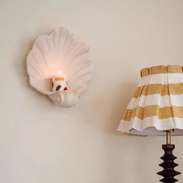 White resin fruit plate ornament with detailed simulation shell design on a table.