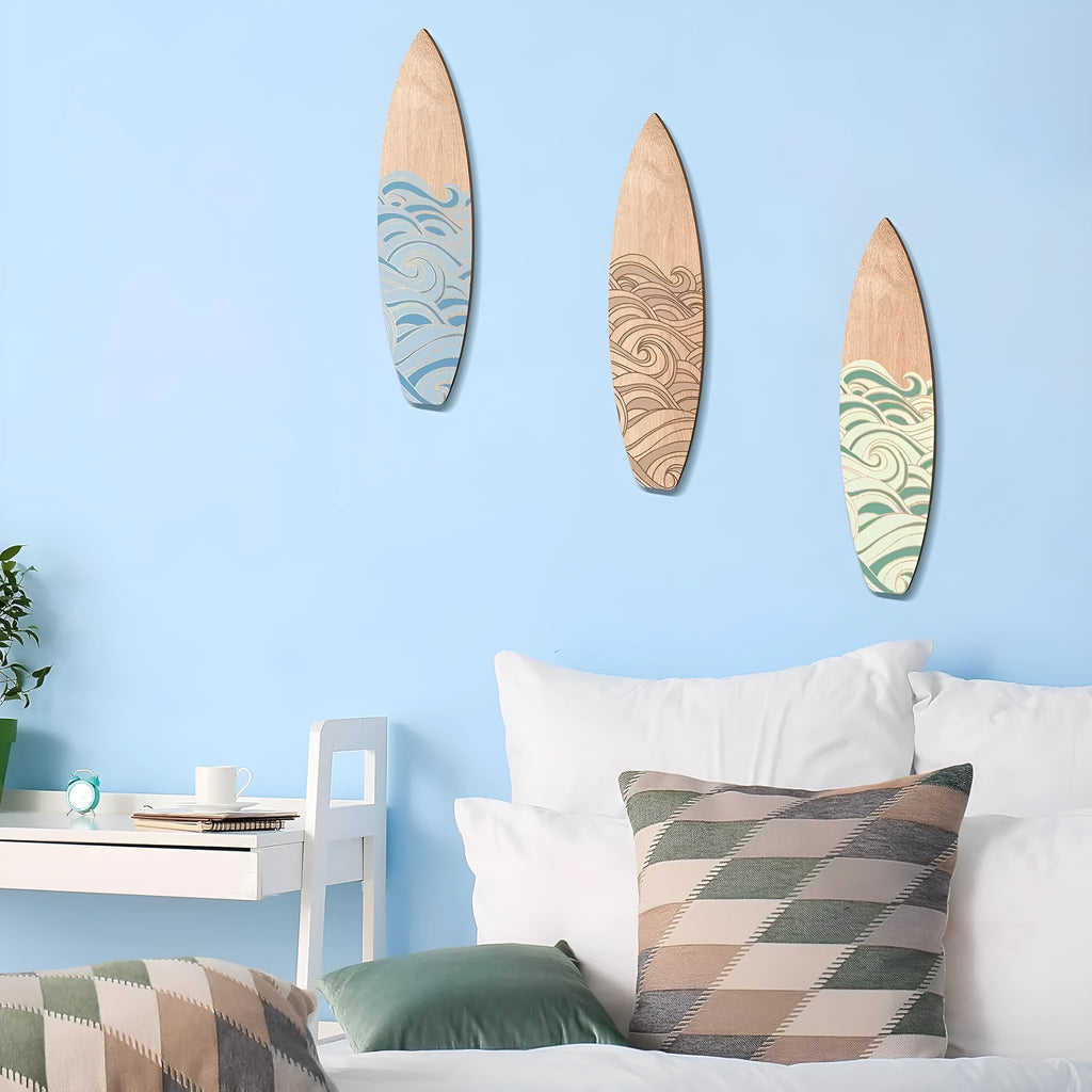 Three identical wooden surfboard shaped wall decorations on a white background