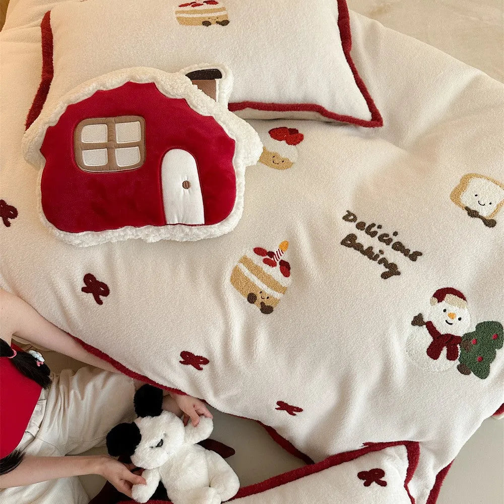 Winter Christmas cartoon patterned four-piece bedding set showing duvet cover, bed sheet, and pillowcases on a bed.