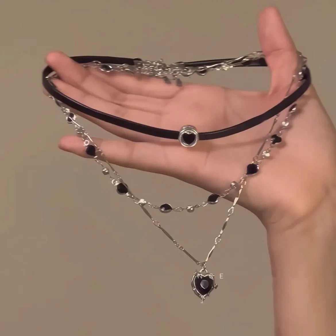Women's leather heart necklace set showing double-layer and single-layer pendant designs on adjustable clavicle chain