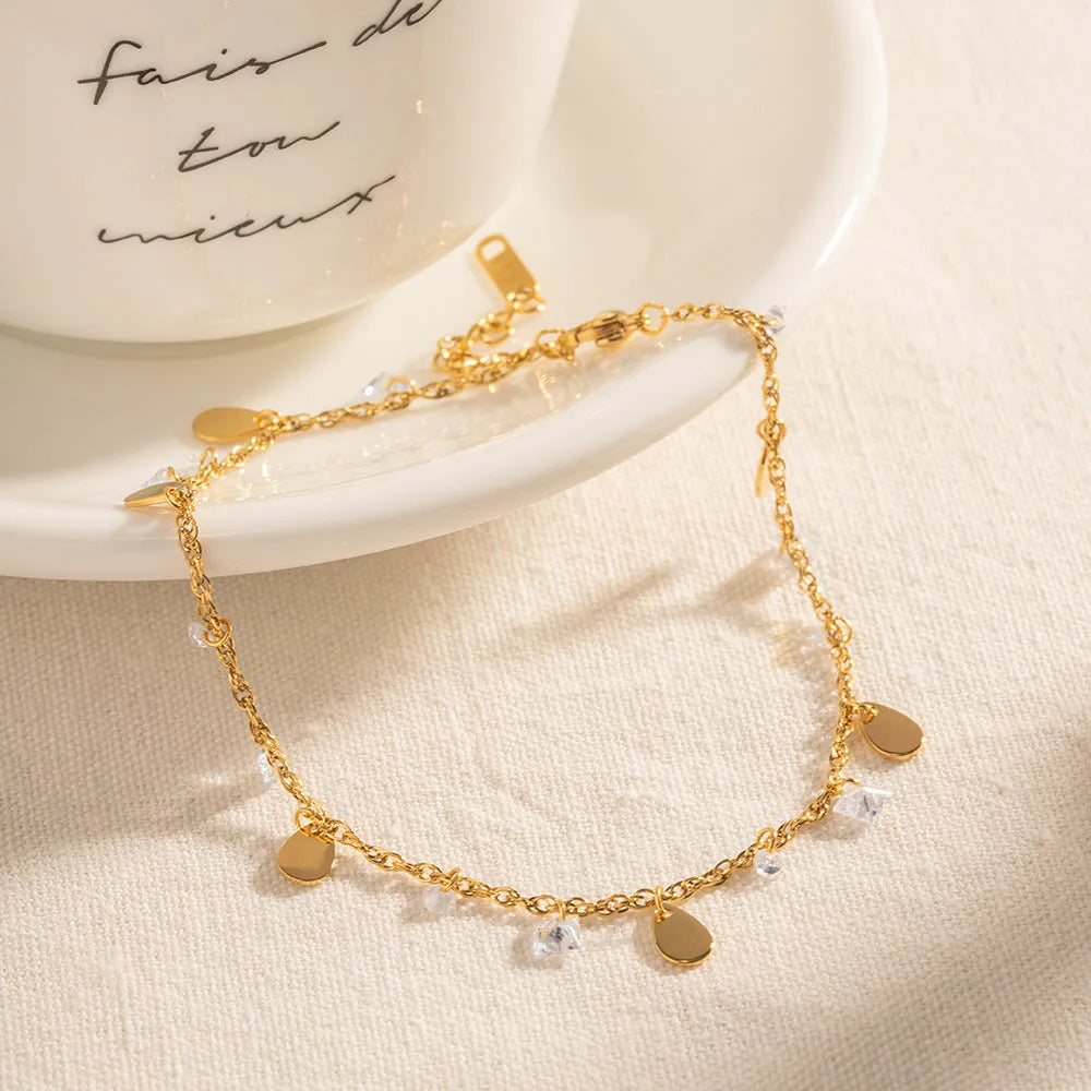 Silver-tone stainless steel anklet with a geometric water drop tassel charm on an adjustable chain.
