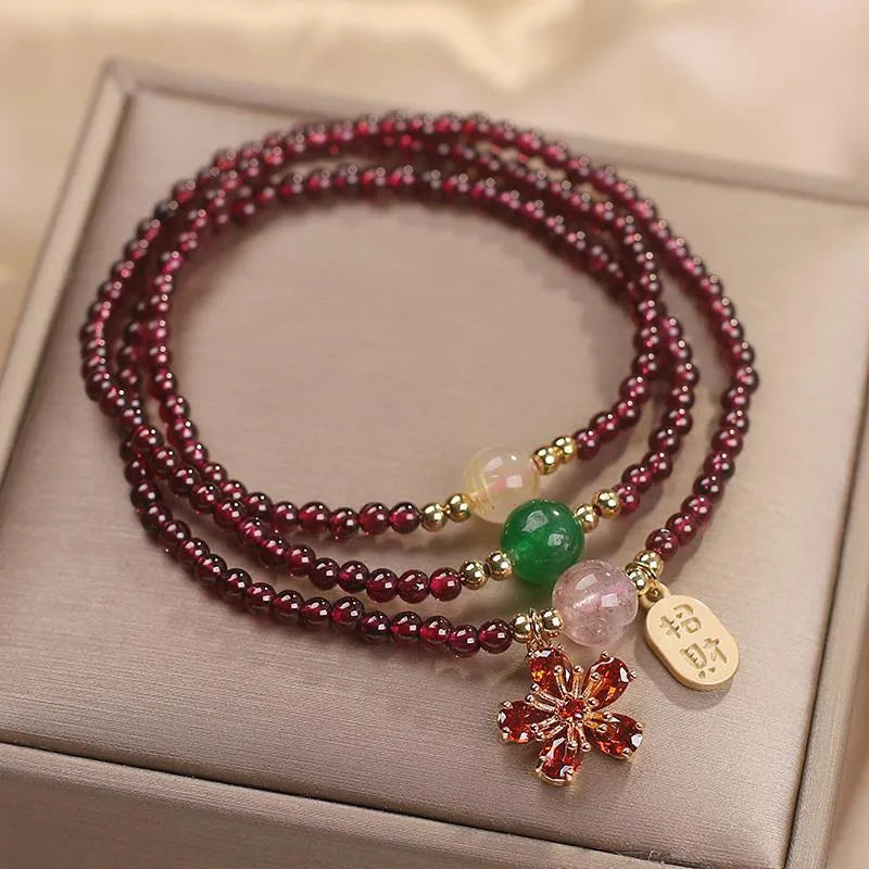 Natural crystal pomegranate red cherry blossom bracelet with sequins on wrist