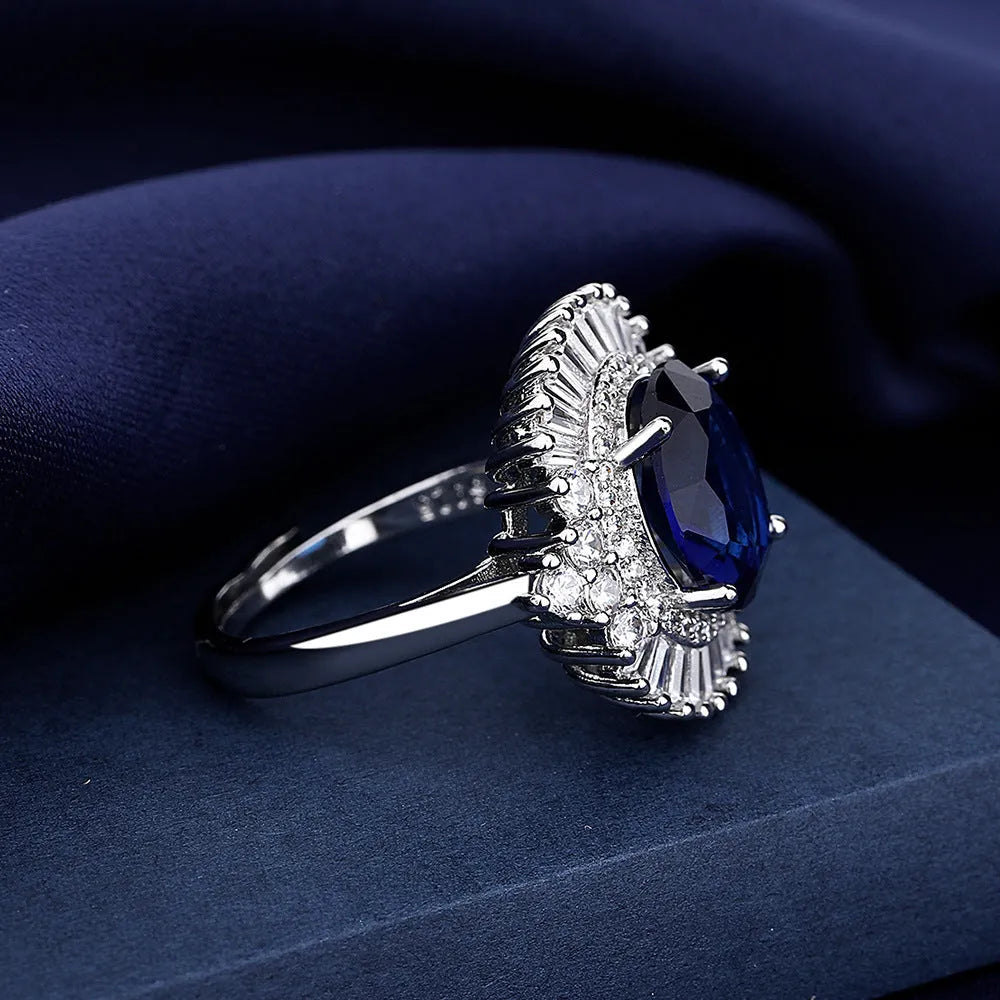 White gold colour copper crown shape ring with sea blue heart centrepiece and open mouth adjustable design