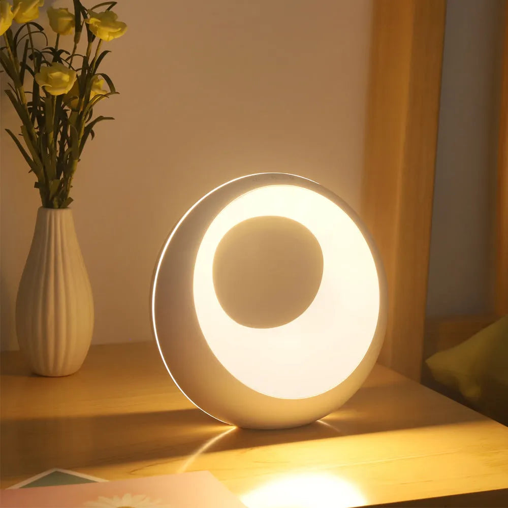 Small creative touch RGB colour changing desk lamp with remote control on a wooden surface