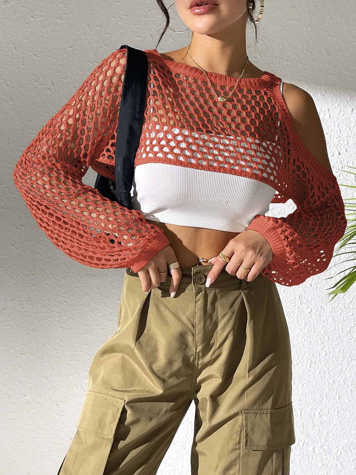 Mesh shirt with a hollowed design at the navel, shown in a selection of colours including army green and red.