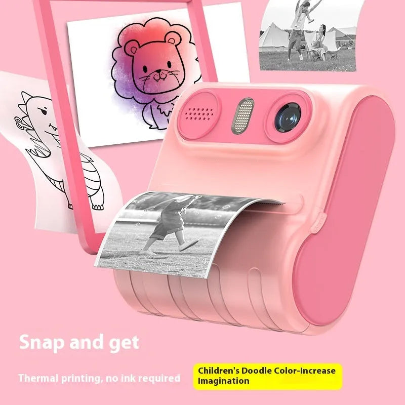 Children's instant printing camera with dual HD cameras in pink colour, showing included lanyard and printing paper