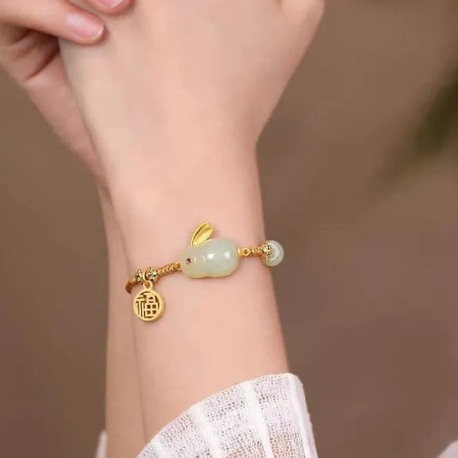 Hetian jade rabbit charm bracelet on yellow string with geometric shape