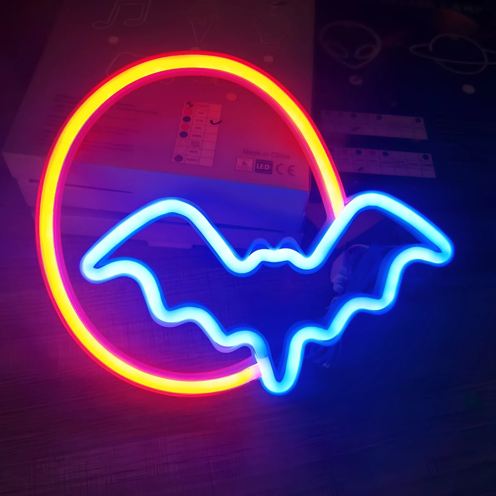 Halloween bat shaped neon light with plastic shell in pink and blue colour options on a dark background
