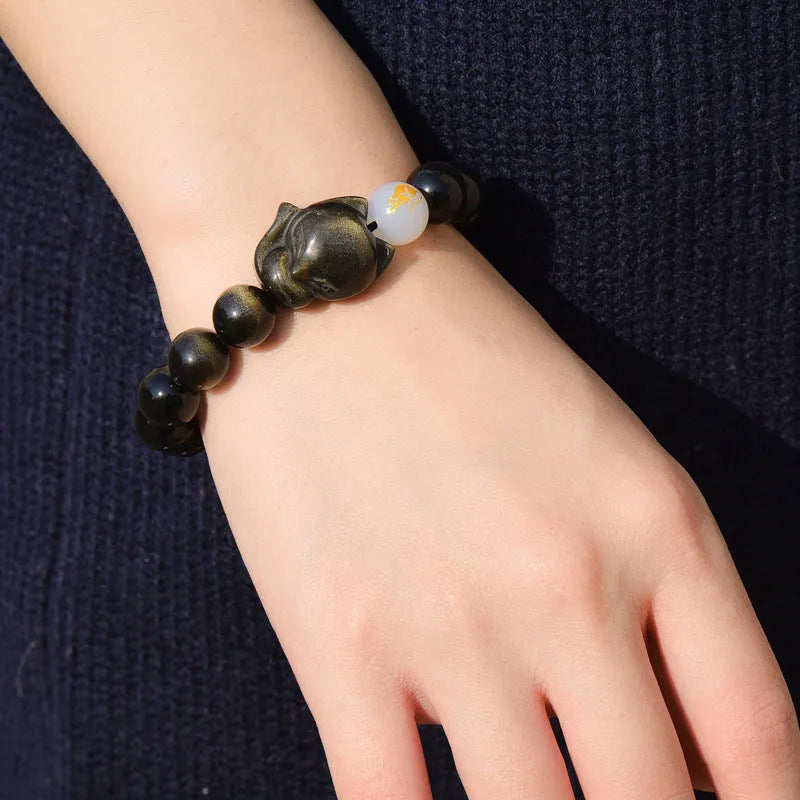 Natural black obsidian bracelet with 10mm beads and zodiac design in gold, silver, or pure stone variations