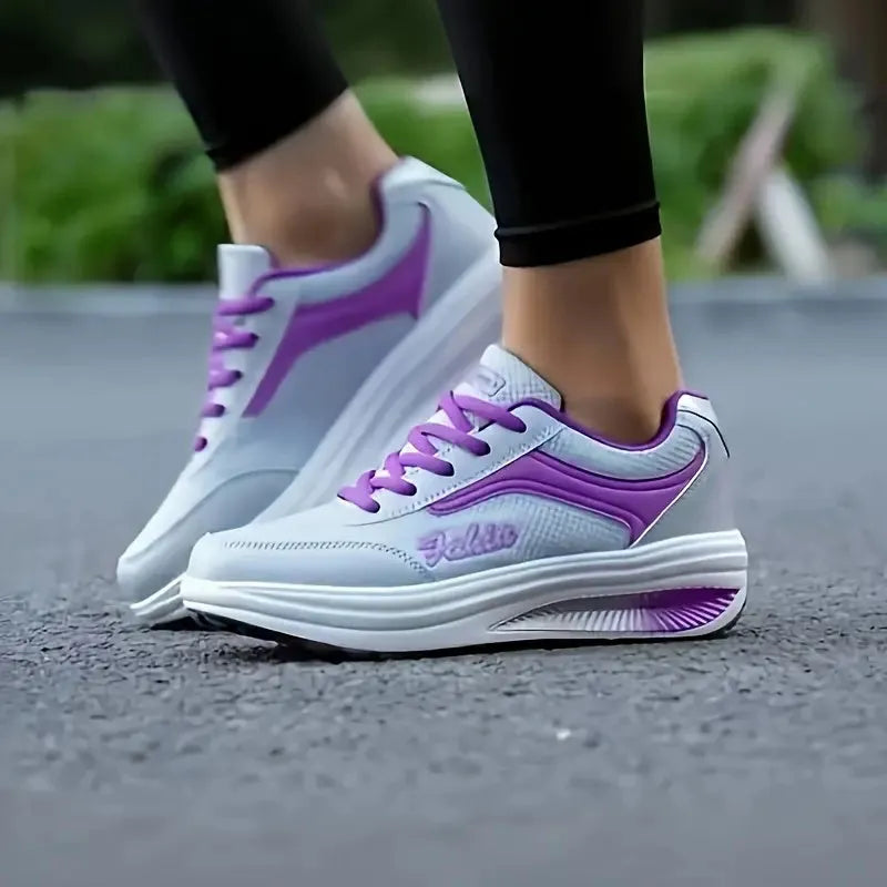 Women's heelless sports travel shoes in a grey colour with a middle heel, shown on a light background.