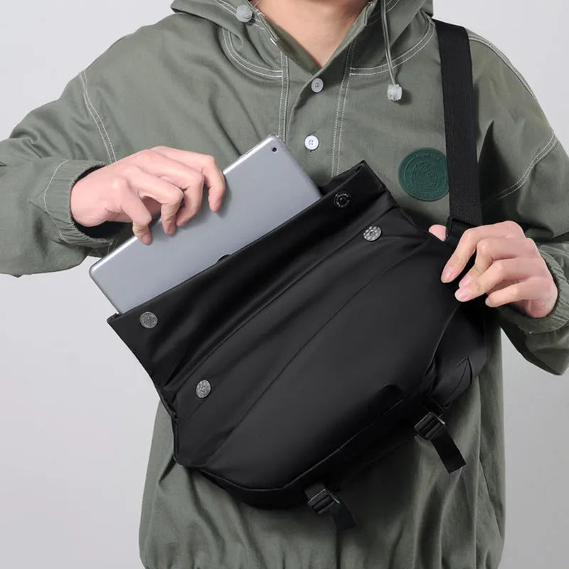 Grey men's medium crossbody bag with shoulder strap showing zipper opening and horizontal square shape
