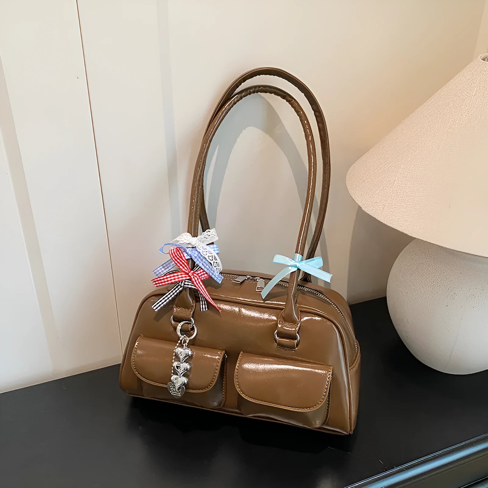 Retro style women's PU leather pillow-shaped flap handbag in black, shown with a double shoulder strap.
