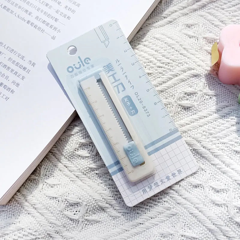 Small plastic art knife in blue colour measuring 7.2cm long for cutting paper and packages