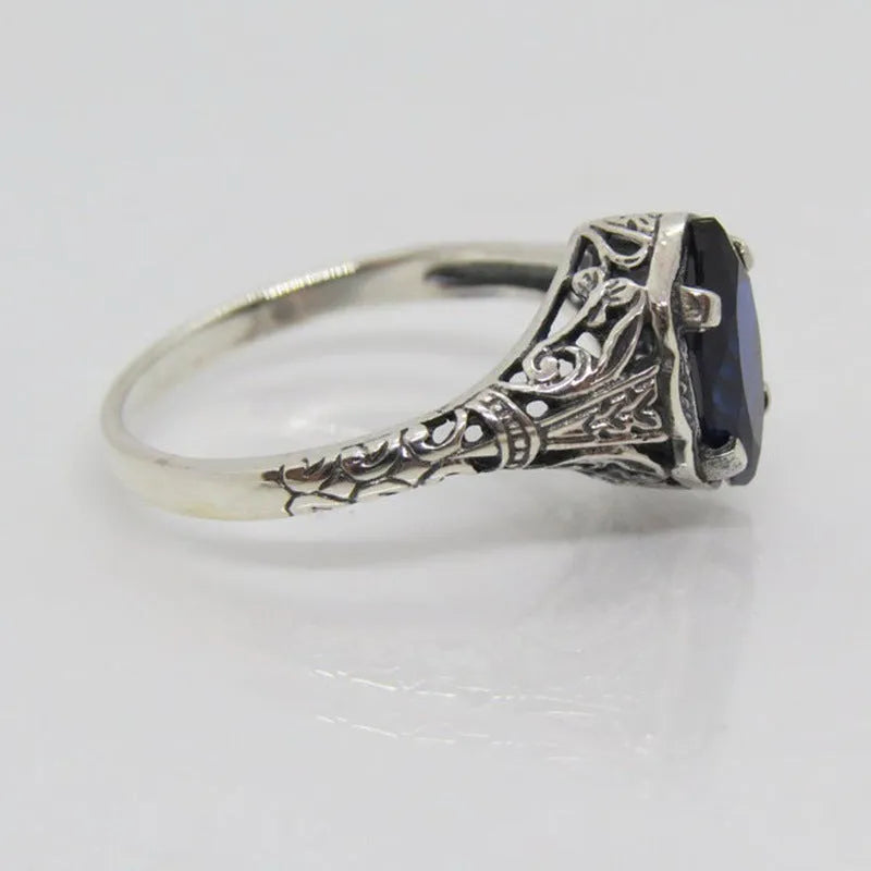 Women's silver geometric hollow ring showing alloy construction and patterned design