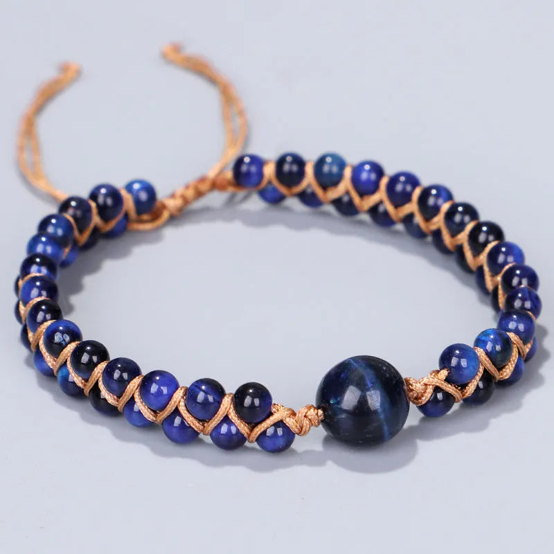 Hand-woven geometric pull bracelet made from blue Tigereye stone beads with an adjustable slip knot.