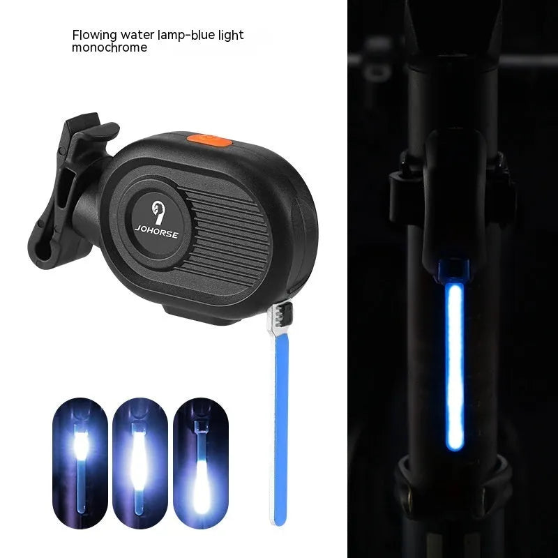 Blue waterfall effect bicycle tail light mounted on a bike seat post, showing dynamic LED light pattern.