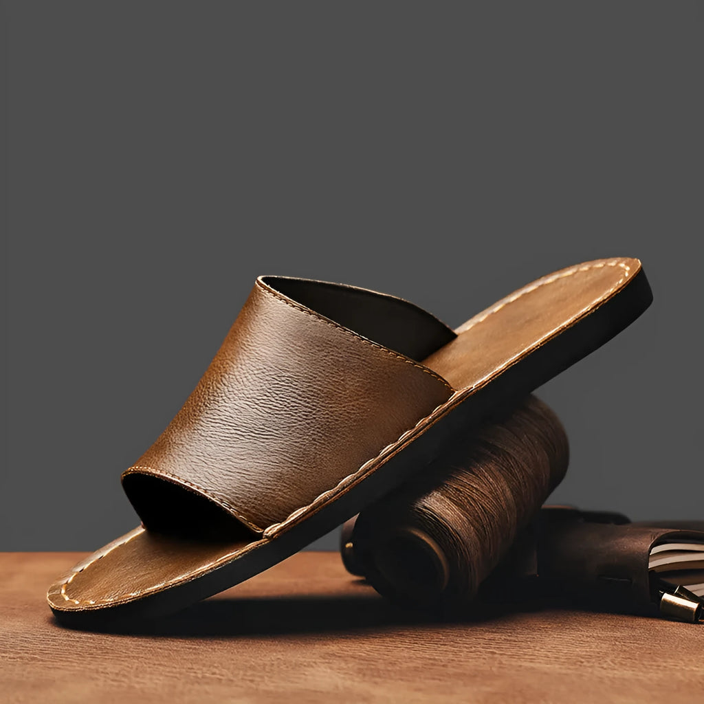 Brown men's leather sandal with rubber sole on a white background