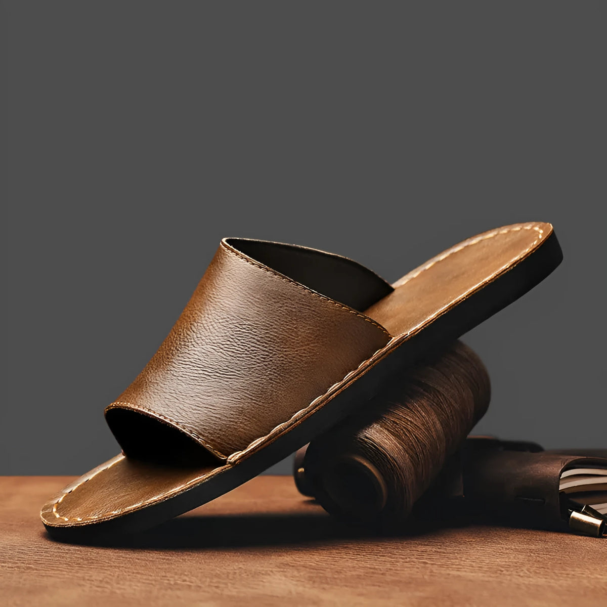 Brown men's leather sandal with rubber sole on a white background