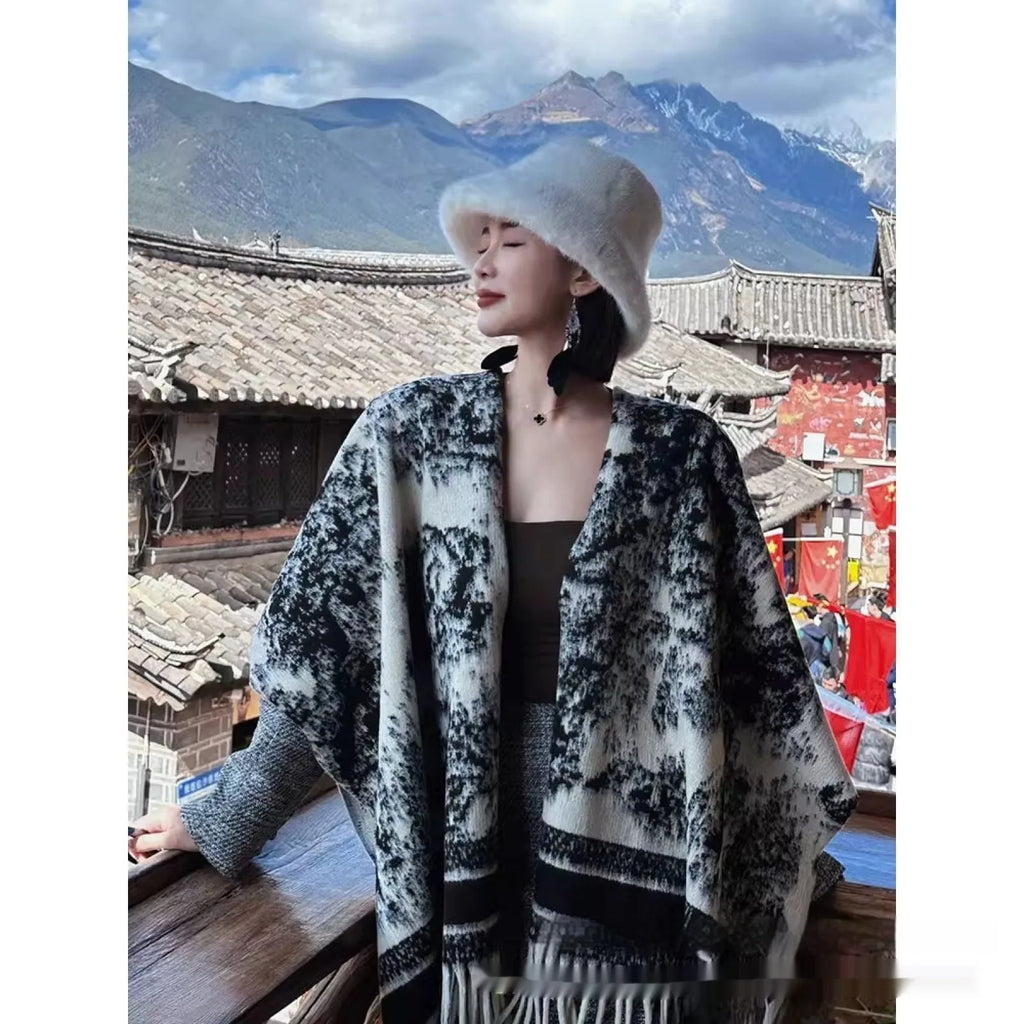 Women's polyester scarf cape with tassels in a choice of five colours, worn as a shawl.