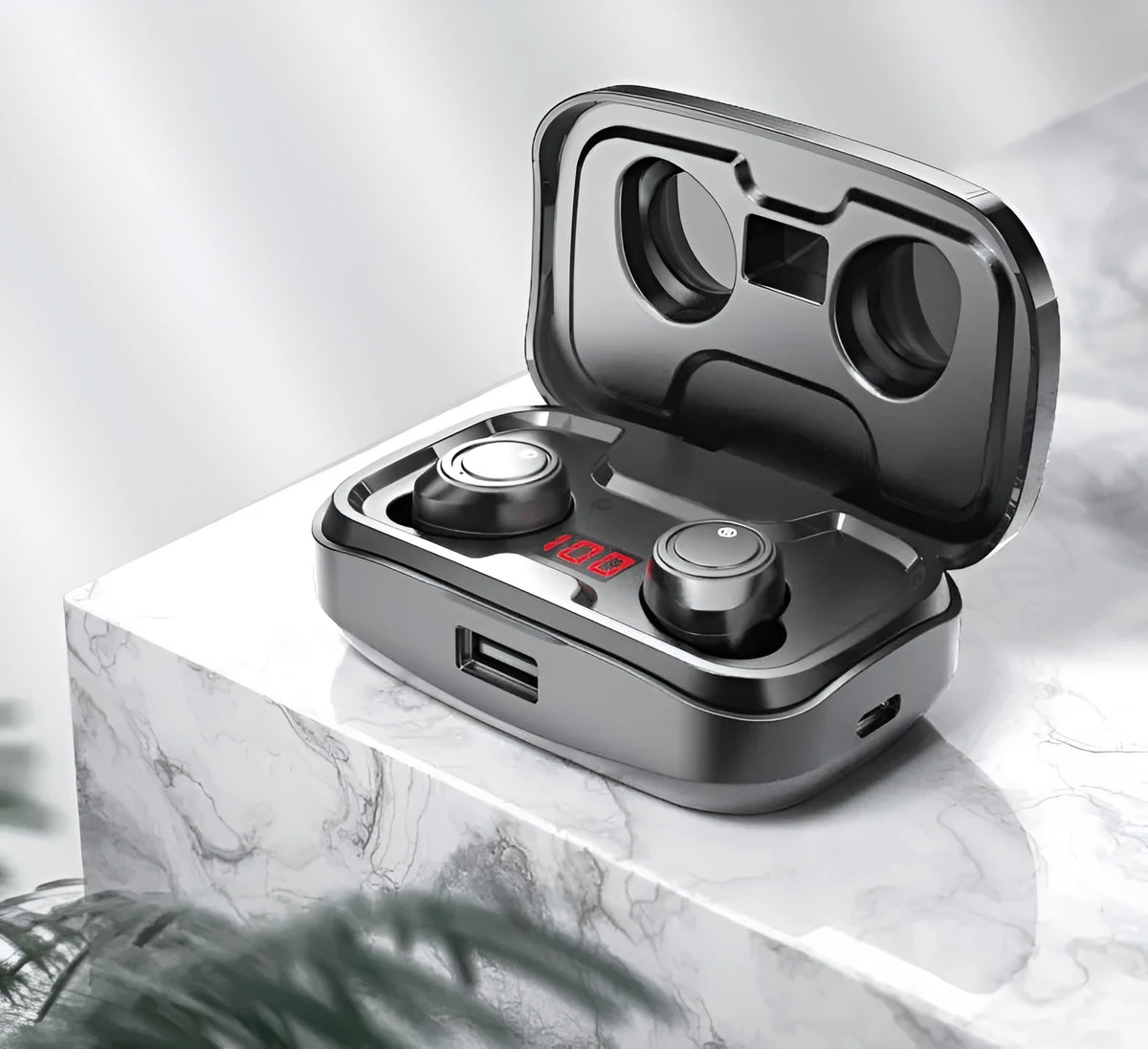 Black Bluetooth earplug-style headset with its charging case on a table