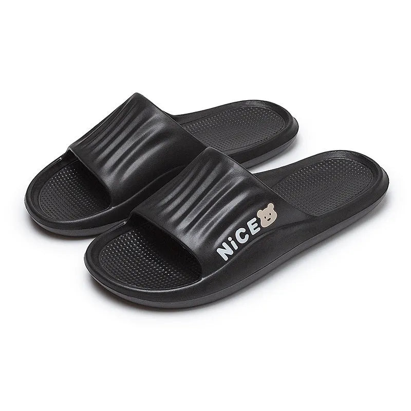 Pair of lightweight EVA flip-flop slippers with a minimalist cartoon pattern and non-slip soles.