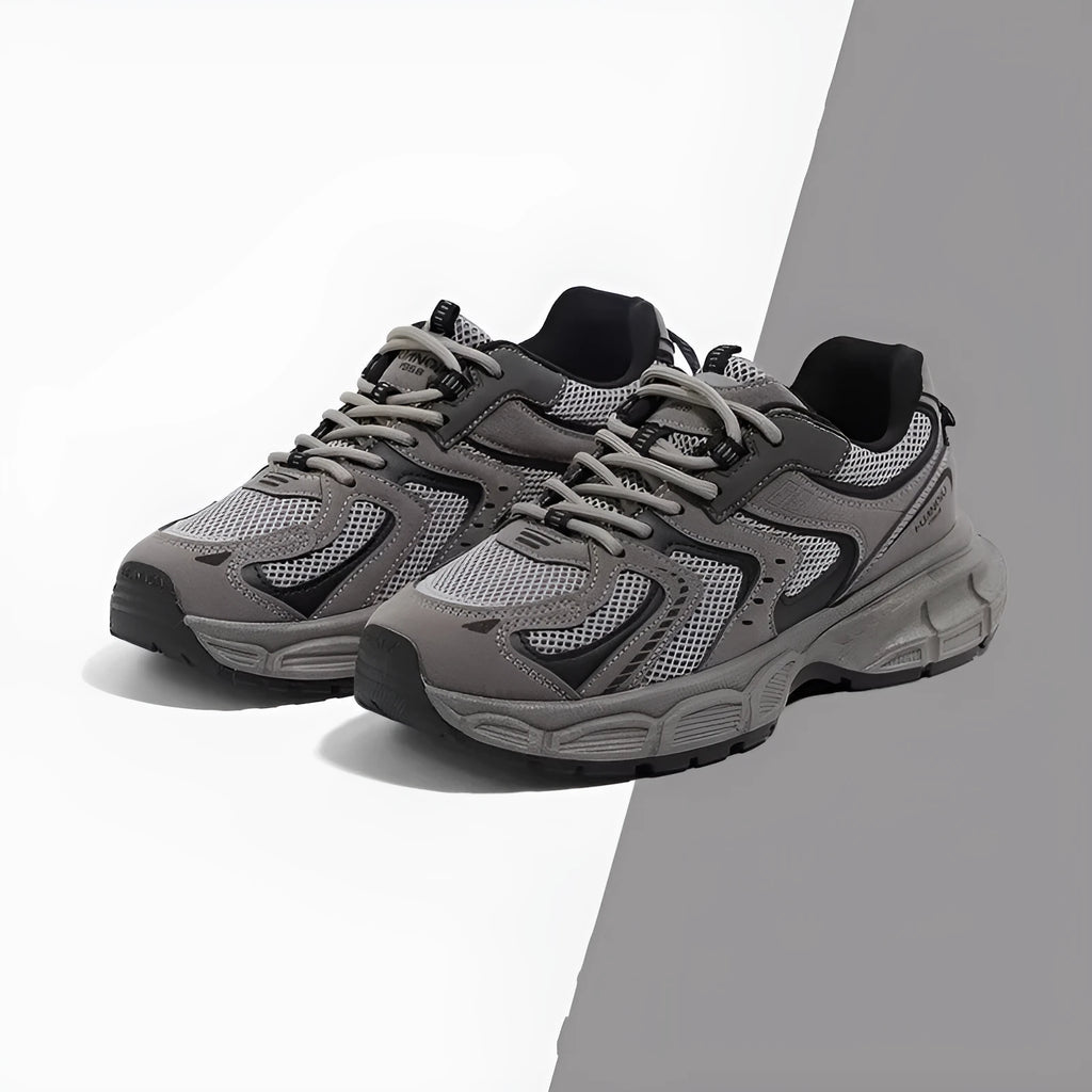 Men's grey low-top platform sneakers with leather stitching on a PU mesh upper and a flat EVA sole.
