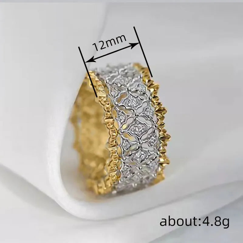 Gold and silver two-tone geometric ring with a central round zircon stone on a copper band.