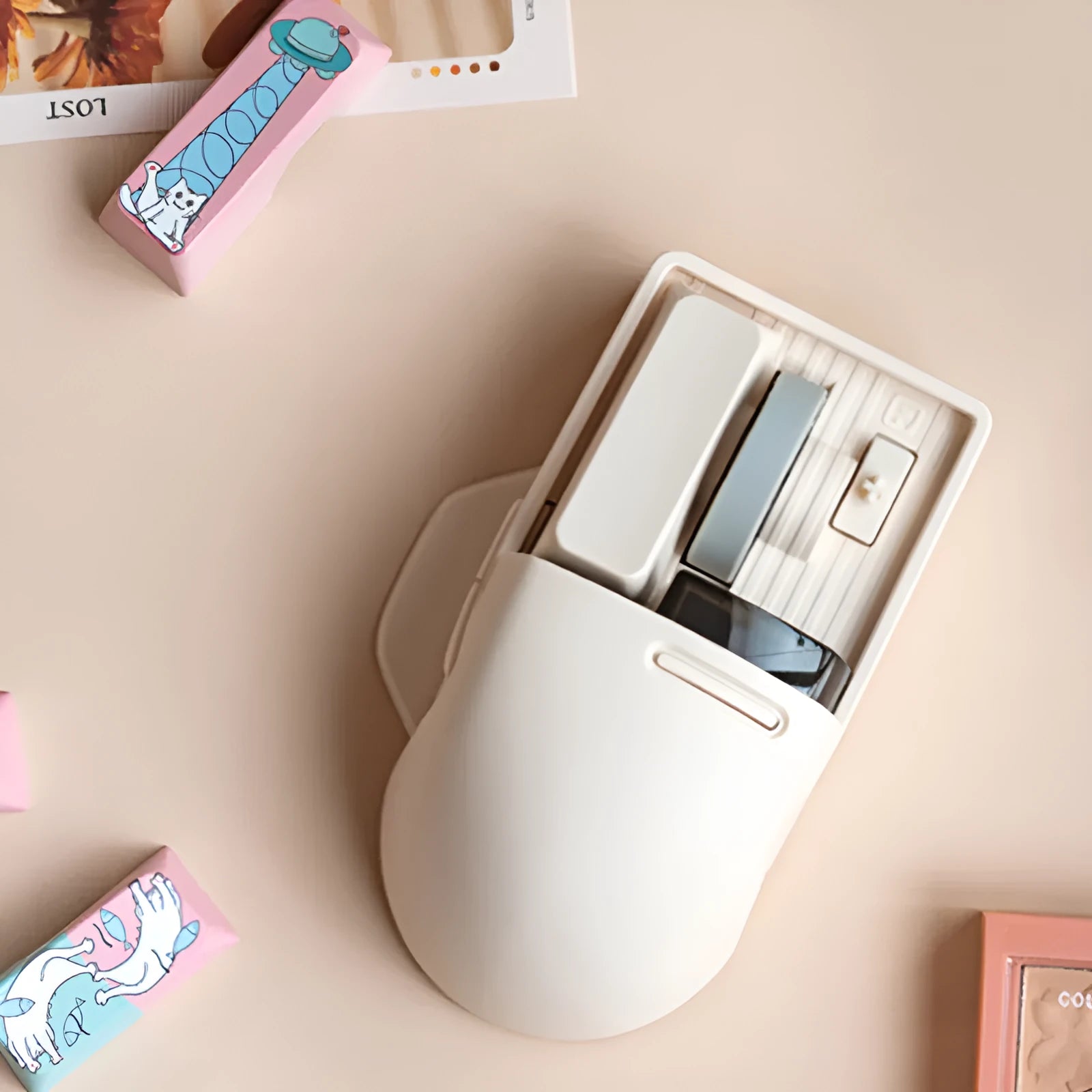 Xiaoqiao Tofu colour wireless mouse with seven buttons and a scroll wheel on a desk.