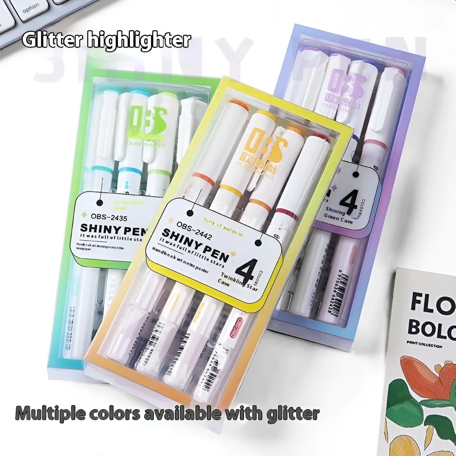 Set of four pastel glitter highlighter pens with slanted tips next to their coloured box.
