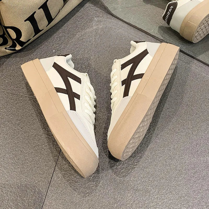 Blue low-top women's casual trainers with round toe and white rubber sole on a plain background.