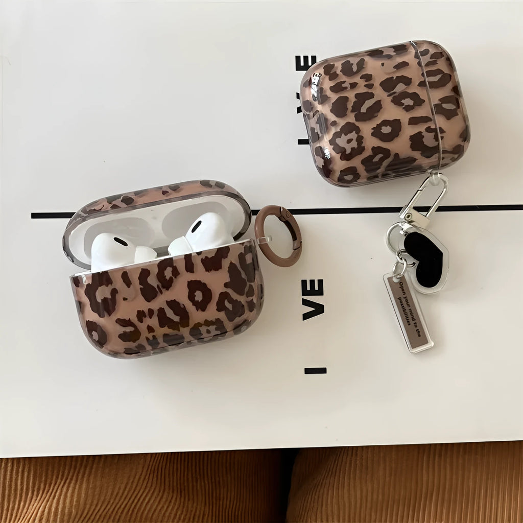 Transparent brown leopard printed PC earphone sleeve on Apple AirPods charging case showing visible logo and spotted pattern