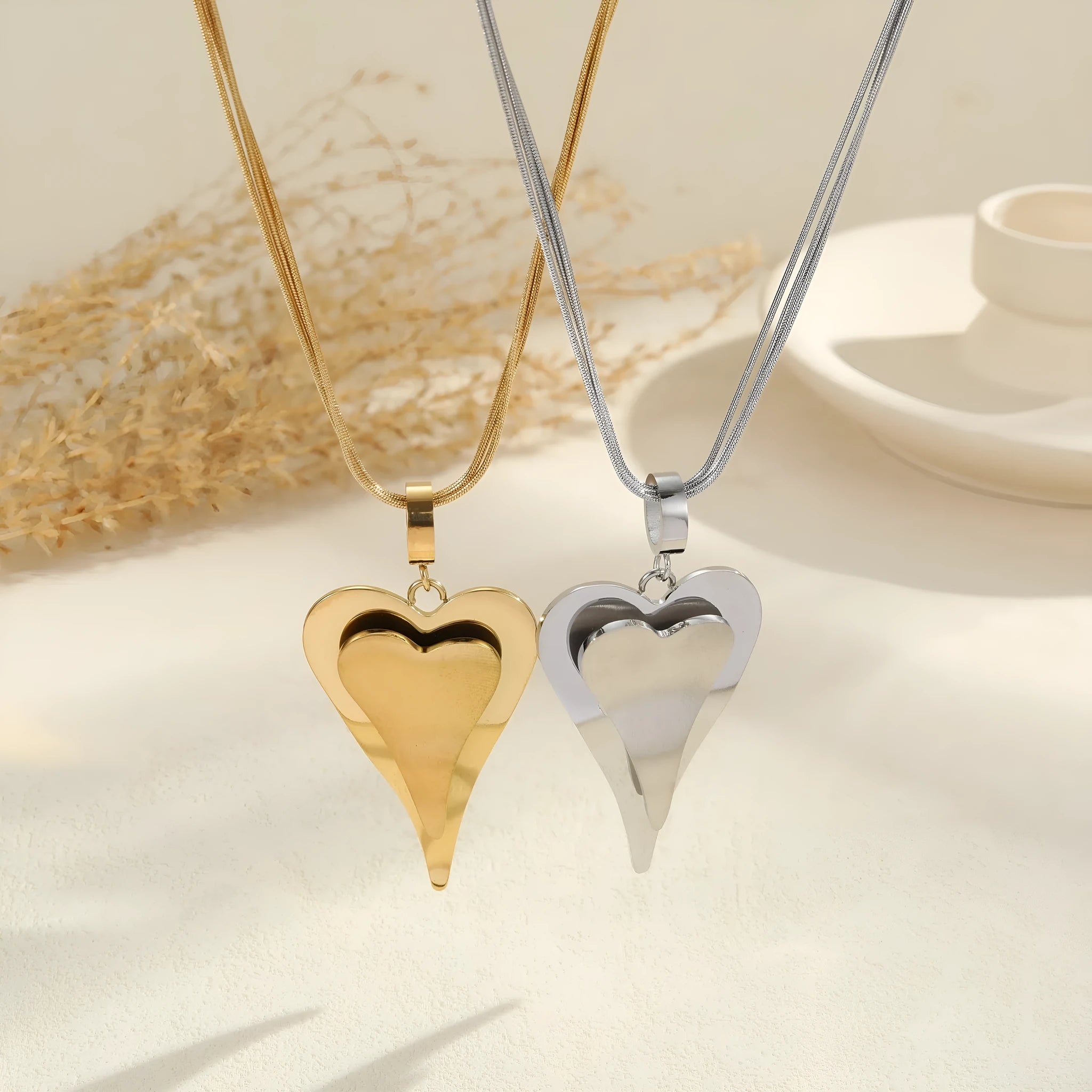 Geometric double heart pendant necklace with snake bones chain pattern in stainless steel