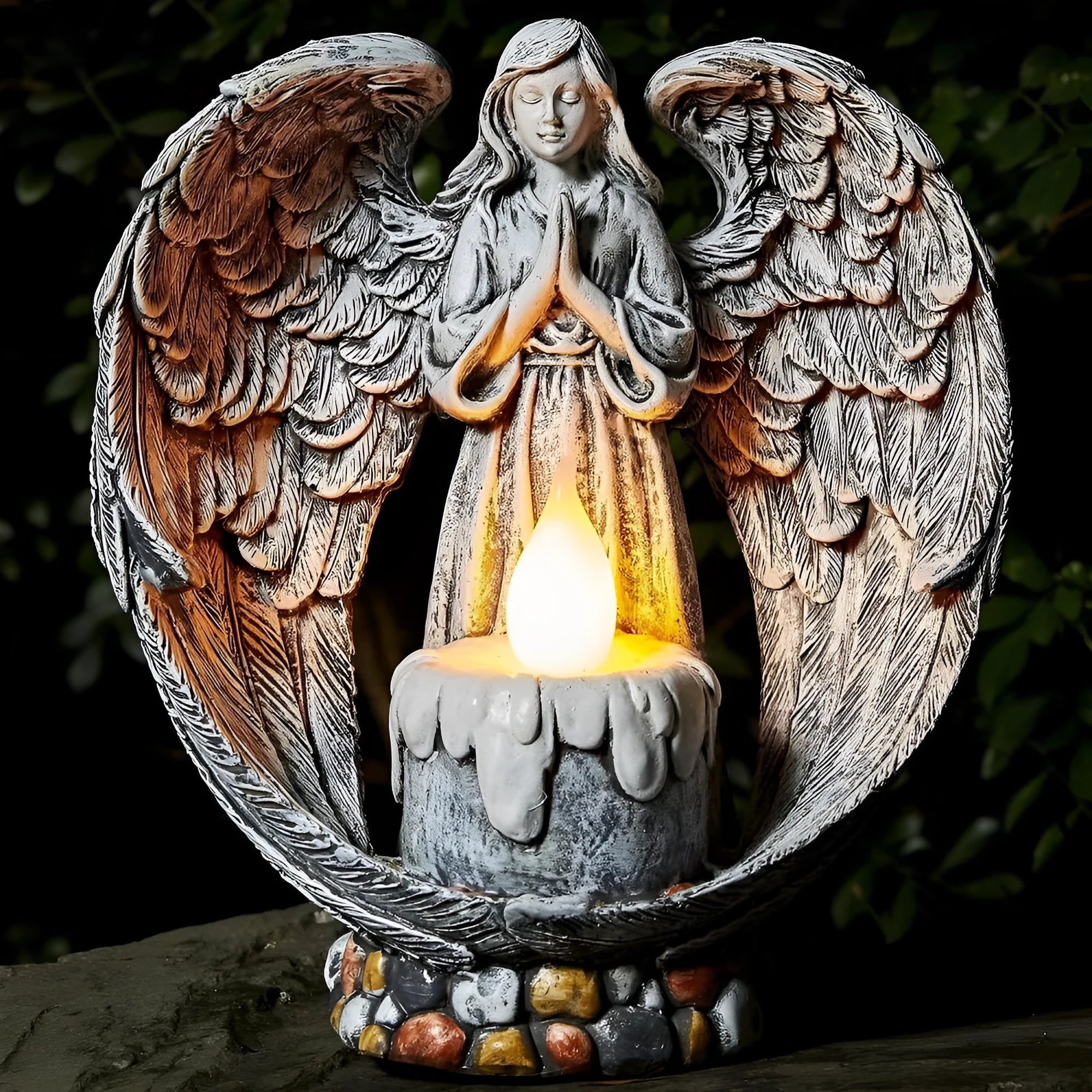 Grey resin praying angel solar garden statue on grass with wings and hands clasped