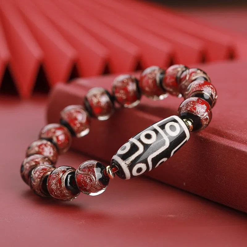 Close-up of a Chinese style coloured glaze bead bracelet with auspicious patterns, showing bead sizing options.