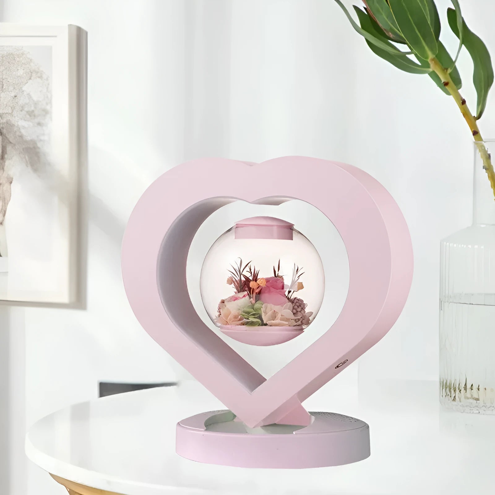 Pink preserved rose ornament gift with optional Bluetooth audio base on a wooden table.