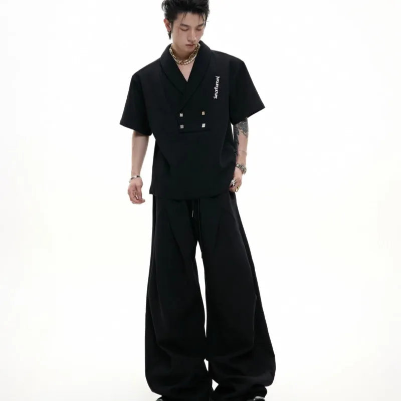 Men's dark grey V-neck padded shoulder sports suit with metal embellishments and matching shorts