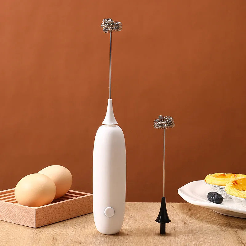 Electric hand-held milk frother in black and white colours for coffee preparation