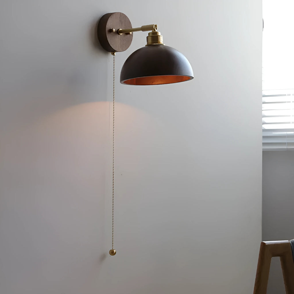 Inn Niche Nordic wooden wall-mounted bedside lamp in walnut colour on a light wall.