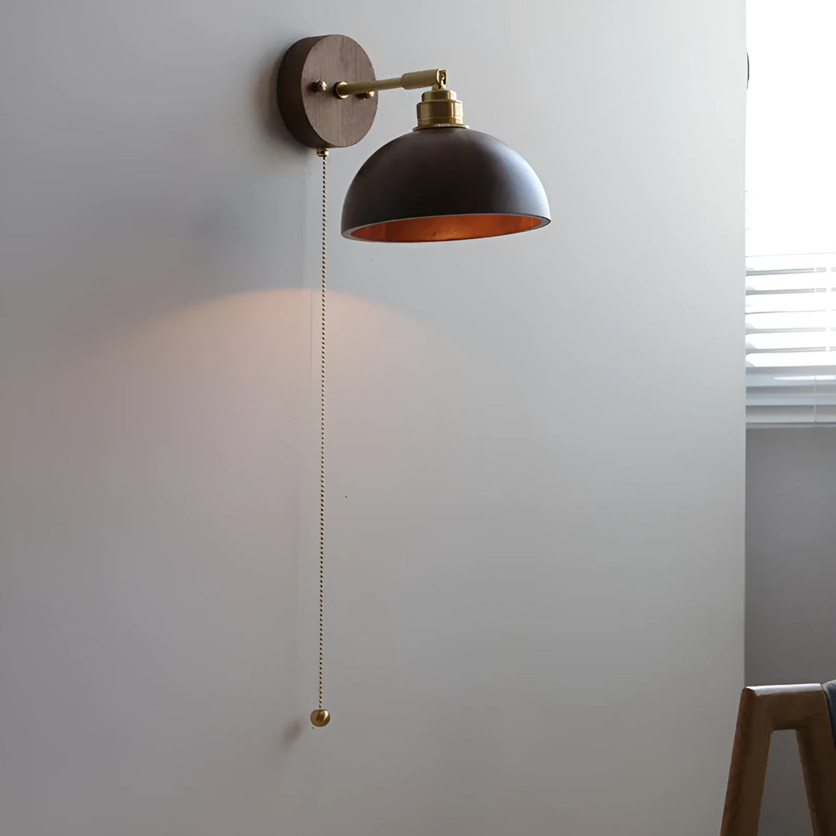 Nordic style wood finish wall lamp mounted beside a bed.