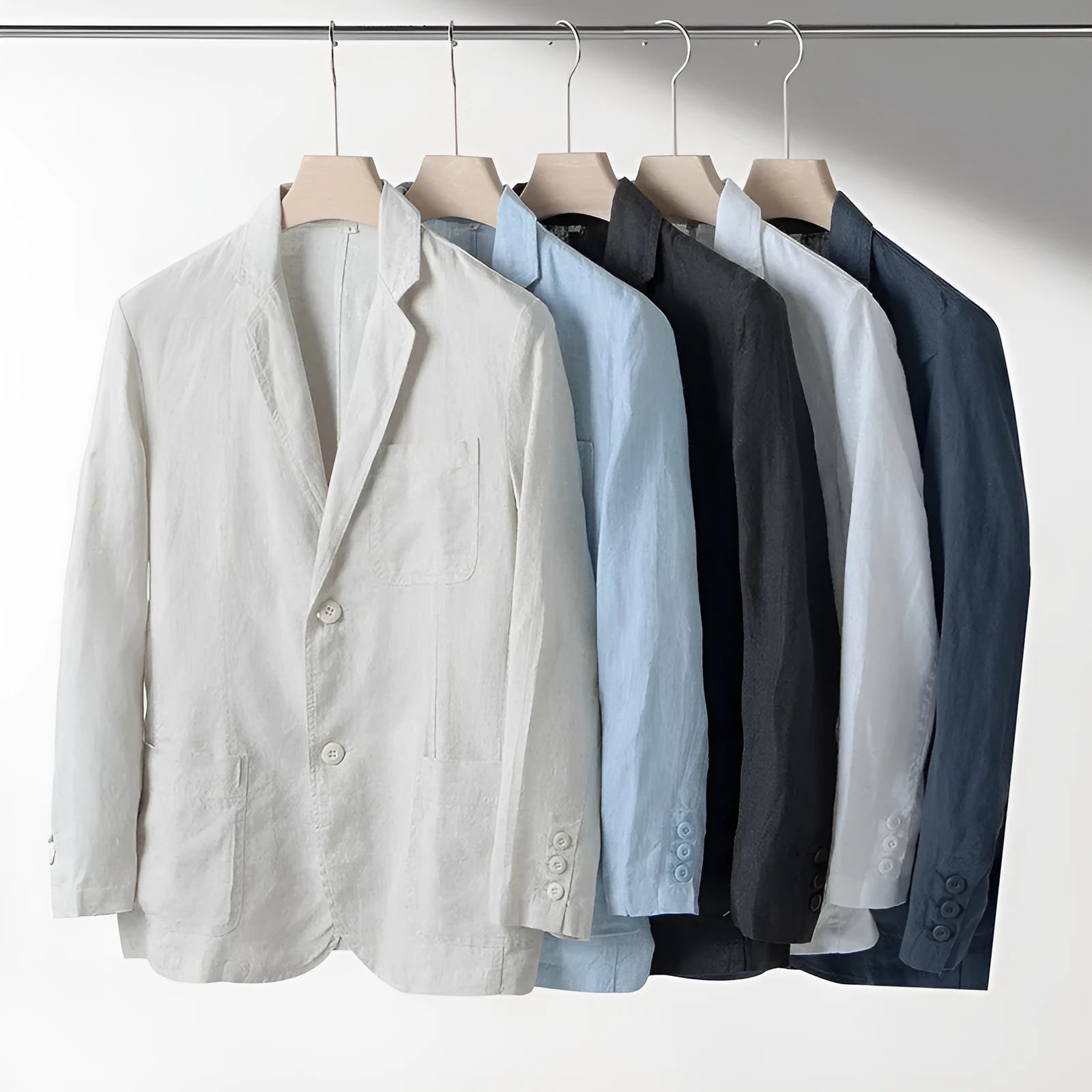 Men's casual linen suit jacket in a solid colour on a hanger, showing long sleeves and a relaxed fit.