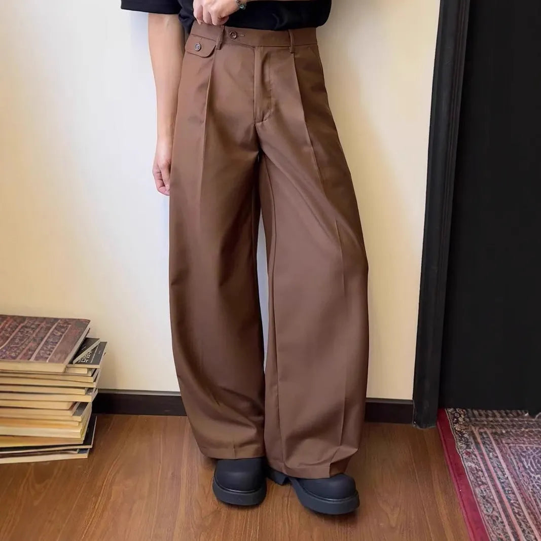 Men's brown straight-leg casual trousers with a loose, wide-leg fit on a neutral background.