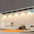Black geometric cat's eye infrared sensor lamp with three colour light on a cabinet shelf