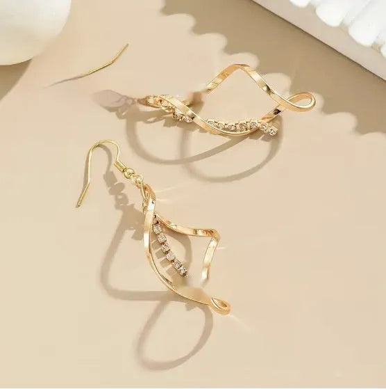 Gold geometric spiral earrings with ellipse elements creating diamond shape design