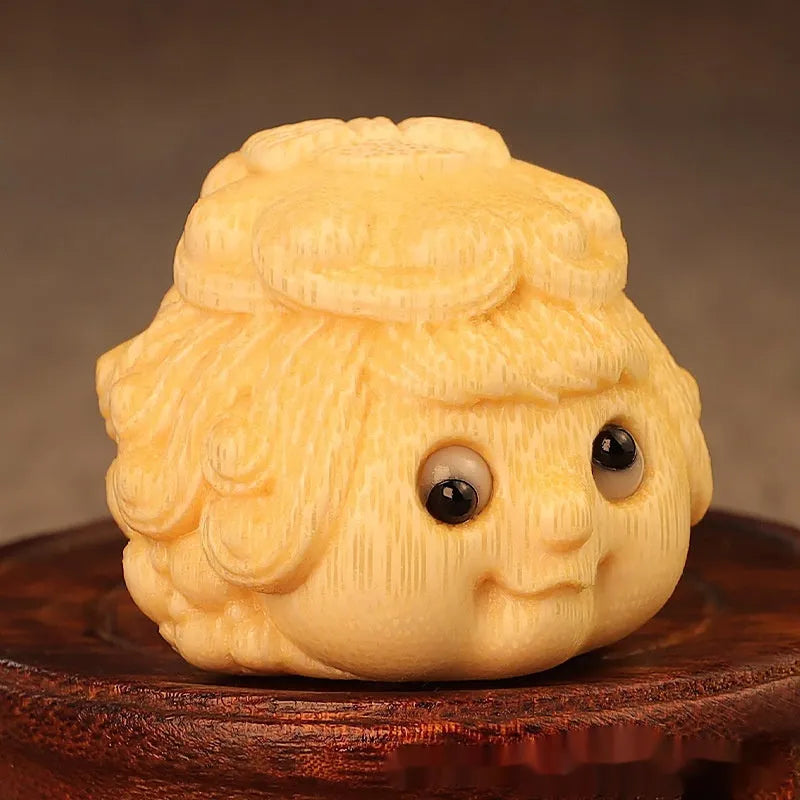 Solid bamboo carving of a cute Golden Toad Princess ornament on a neutral background.